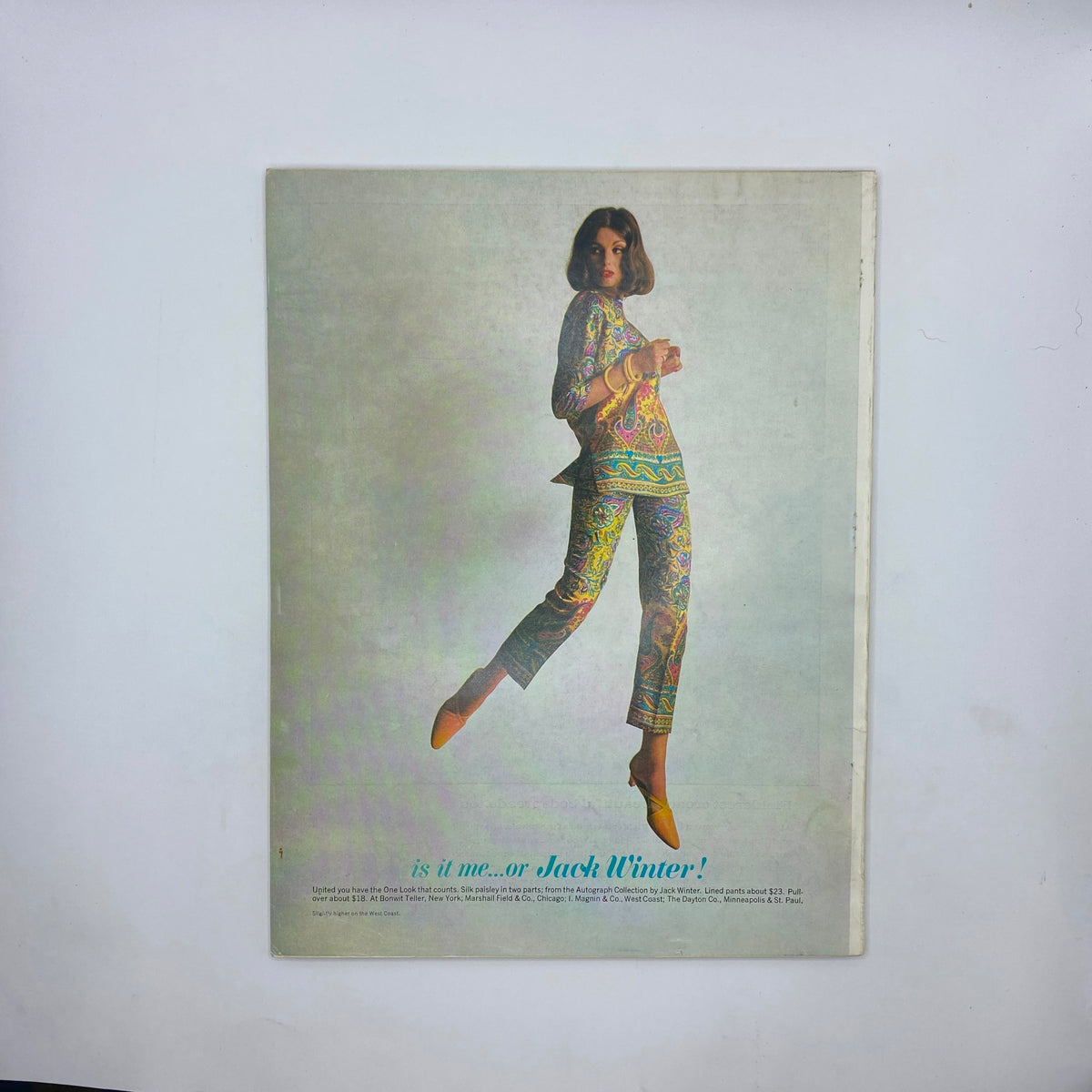 Back cover of VTG Vogue Magazine October 15 1963 featuring a model in colorful, patterned attire with the text asking, 'is it me...or Jack Winter!'