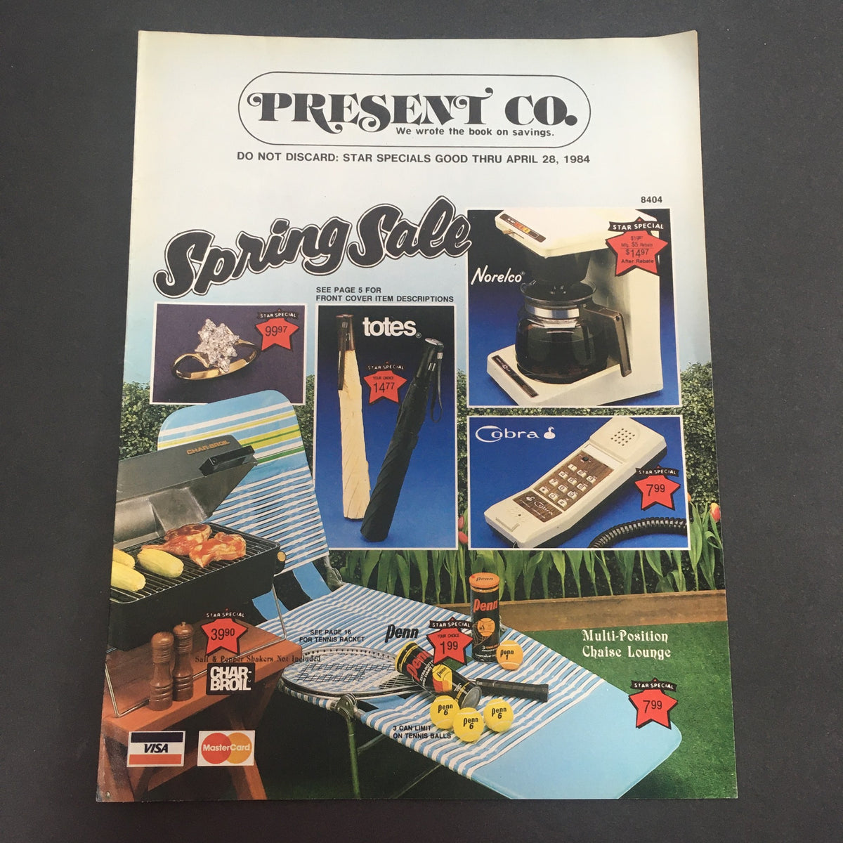 VTG April 28 1984 Present Co. Totes, Norelco, Cobra, Char-Boil Spring Catalog showcasing items like a grill, beach chair, and kitchen appliances, highlighting sale prices in red labels.