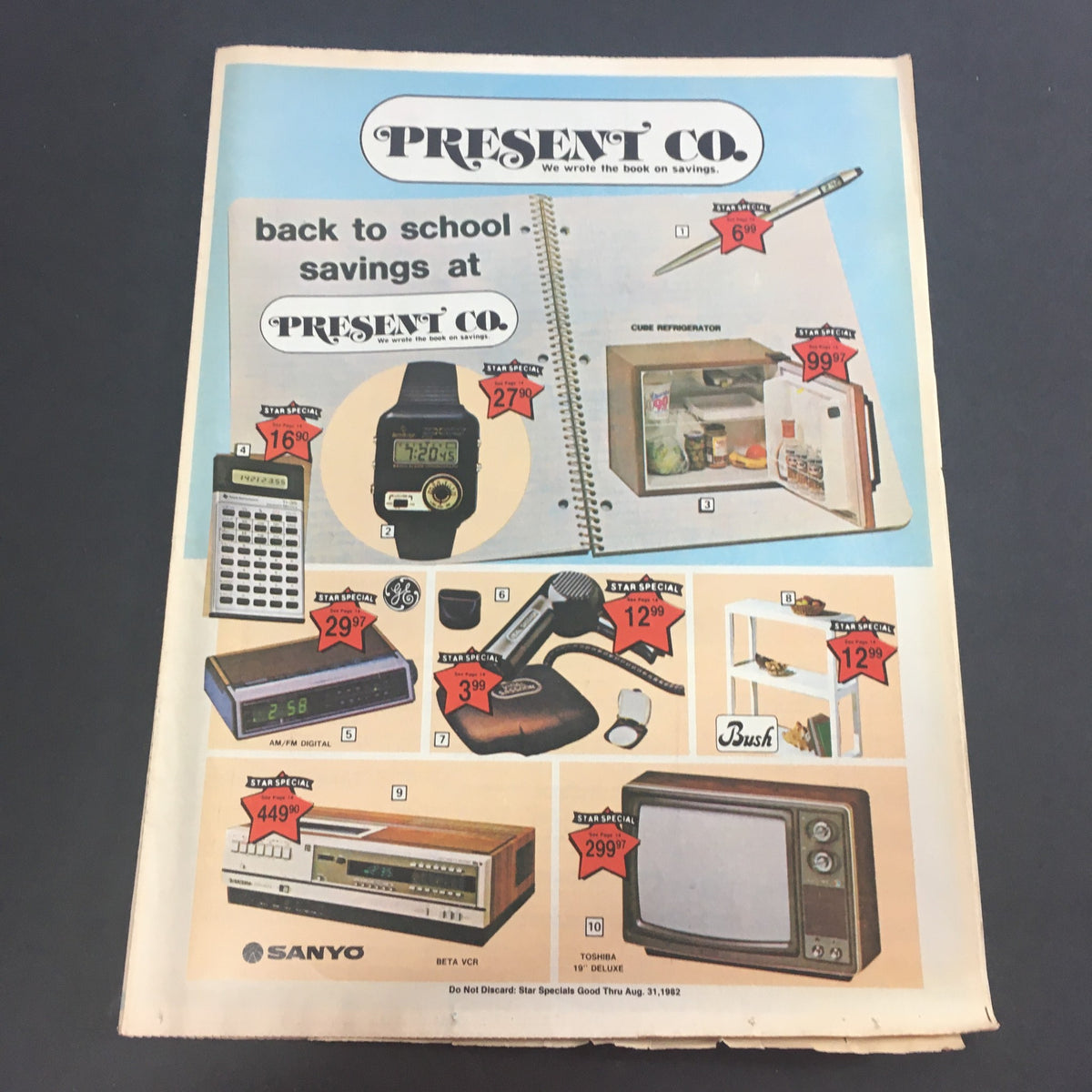 VTG August 1982 Present Co. Back To School Savings Catalog page featuring a variety of products including a watch, calculator, and refrigerator, all with price listings.