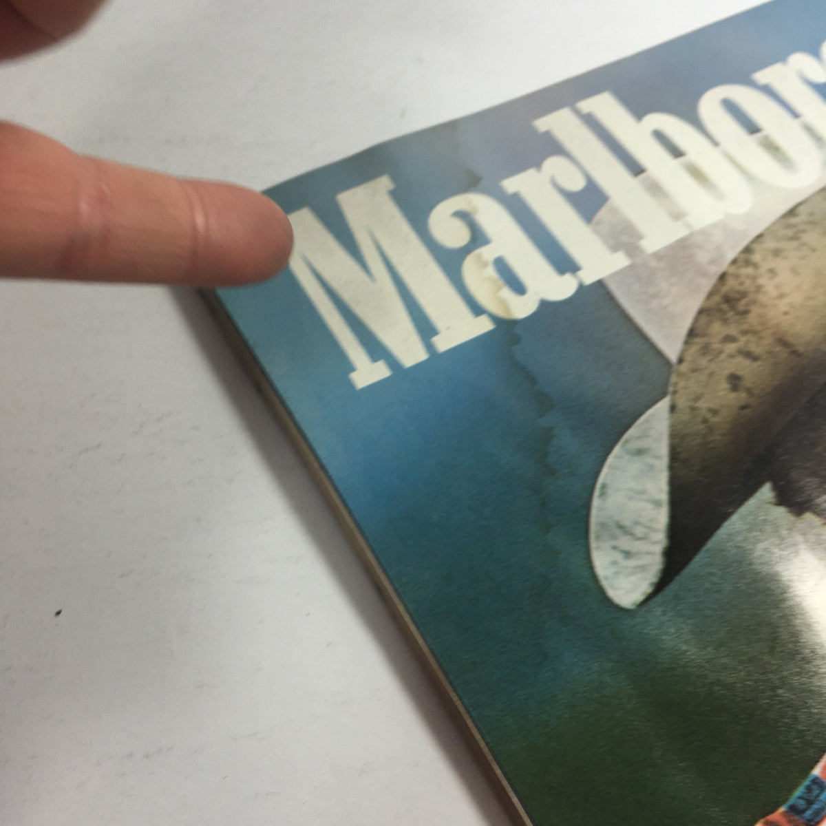Close-up of the cover corner of the VTG USFL Kickoff Official Magazine 1983 Vol. 1 #5 featuring the word 'Marlboro' and indication of vintage wear.