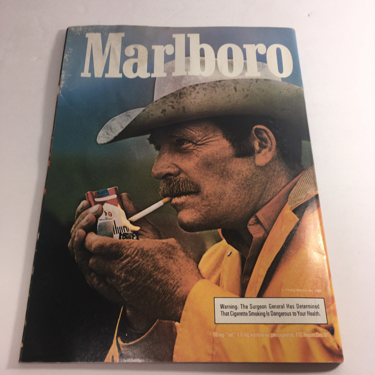 Vintage Marlboro magazine cover featuring a cowboy holding a cigarette pack, promoting the iconic brand in the Smokers' culture from the early 1980s.