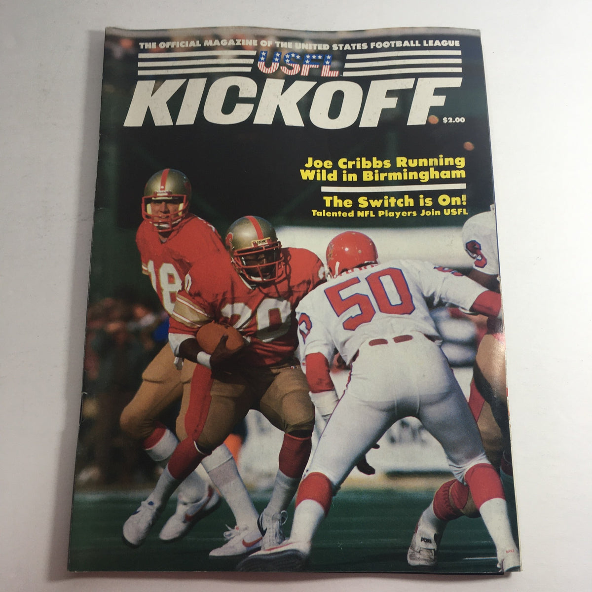 Front cover of the VTG USFL Kickoff Official Magazine 1984 Vol. 2 #4 featuring Joe Cribbs and an exciting football action scene. The cover showcases key highlights like 'Joe Cribbs Running Wild in Birmingham' and 'The Switch is On! Talented NFL Players Join USFL'.