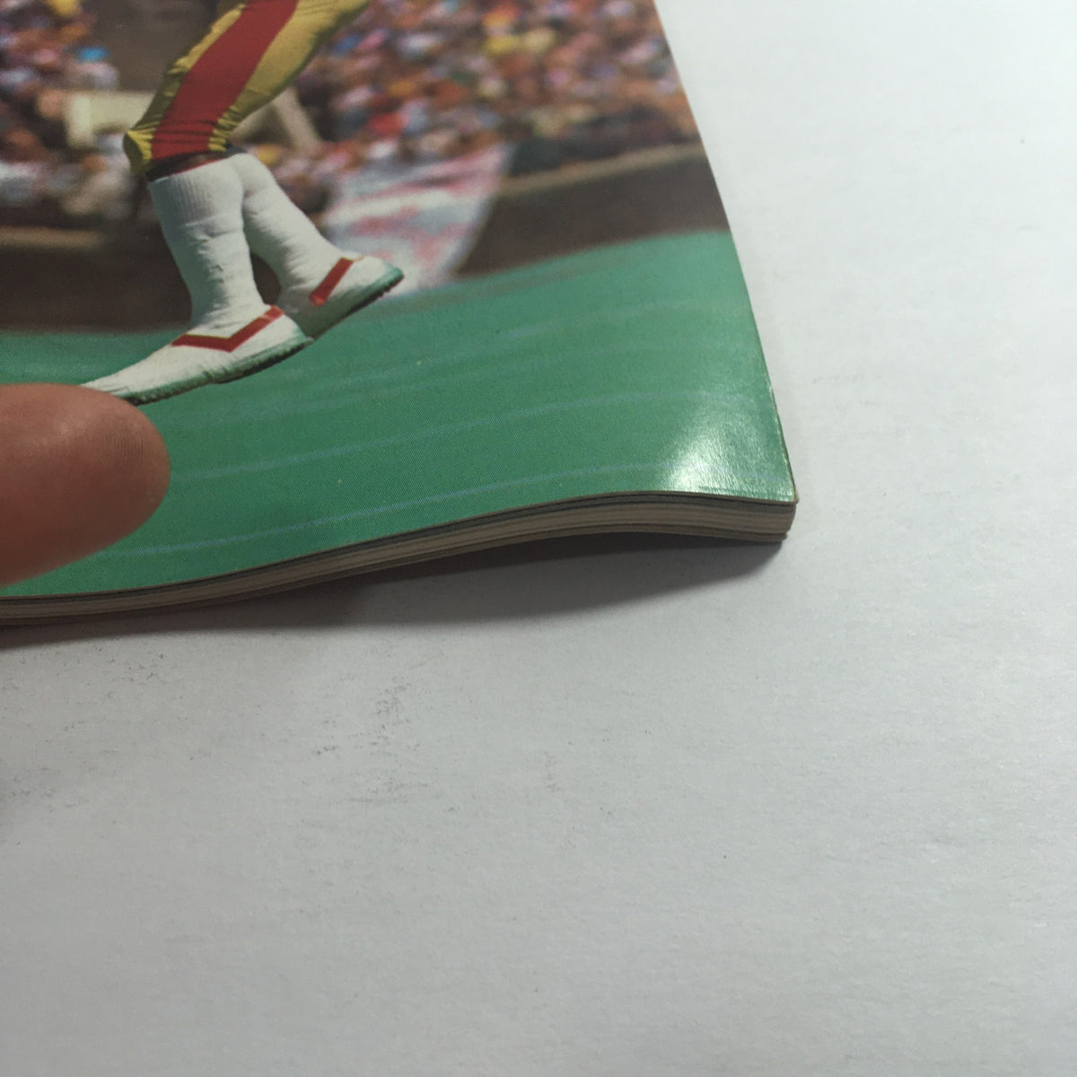Close-up image of the edge of the VTG USFL Kickoff Official Magazine 1985 Vol 3 #6, highlighting its wear and age with a focus on the quality of the magazine.