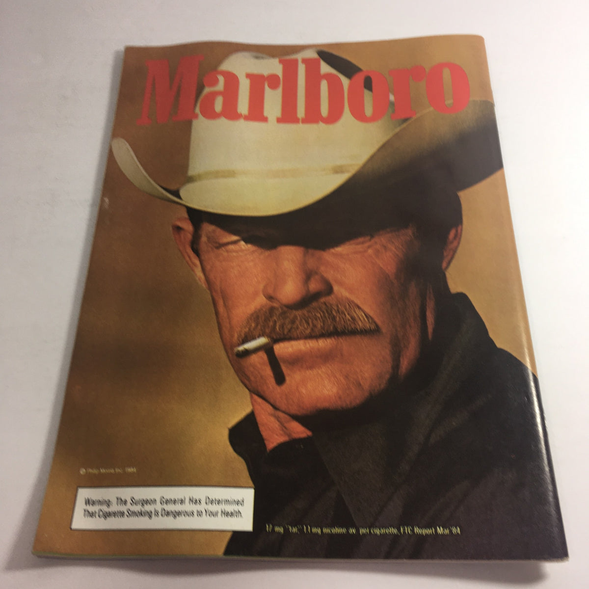 Cover of a Marlboro magazine featuring a cowboy with a cigarette, illustrating the advertising aesthetic of the 1980s.