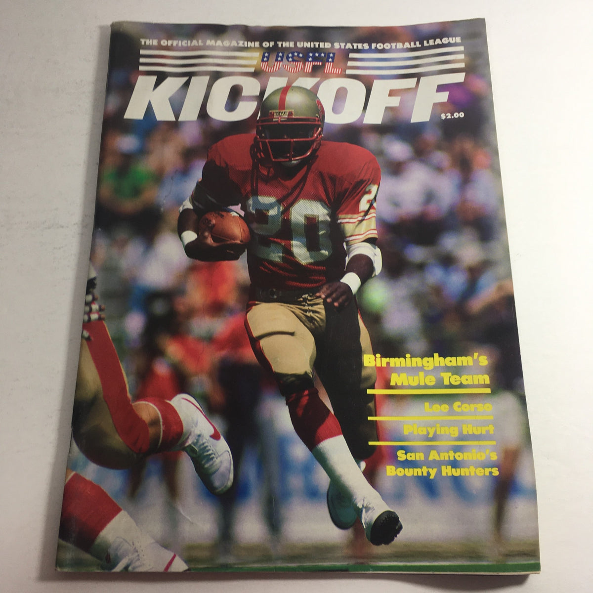 Vintage USFL Kickoff Official Magazine 1985, Volume 3, Issue 2 featuring player number 20 on the cover, showcasing Birmingham's Mule Team, Lee Corso, and San Antonio's Bounty Hunters.