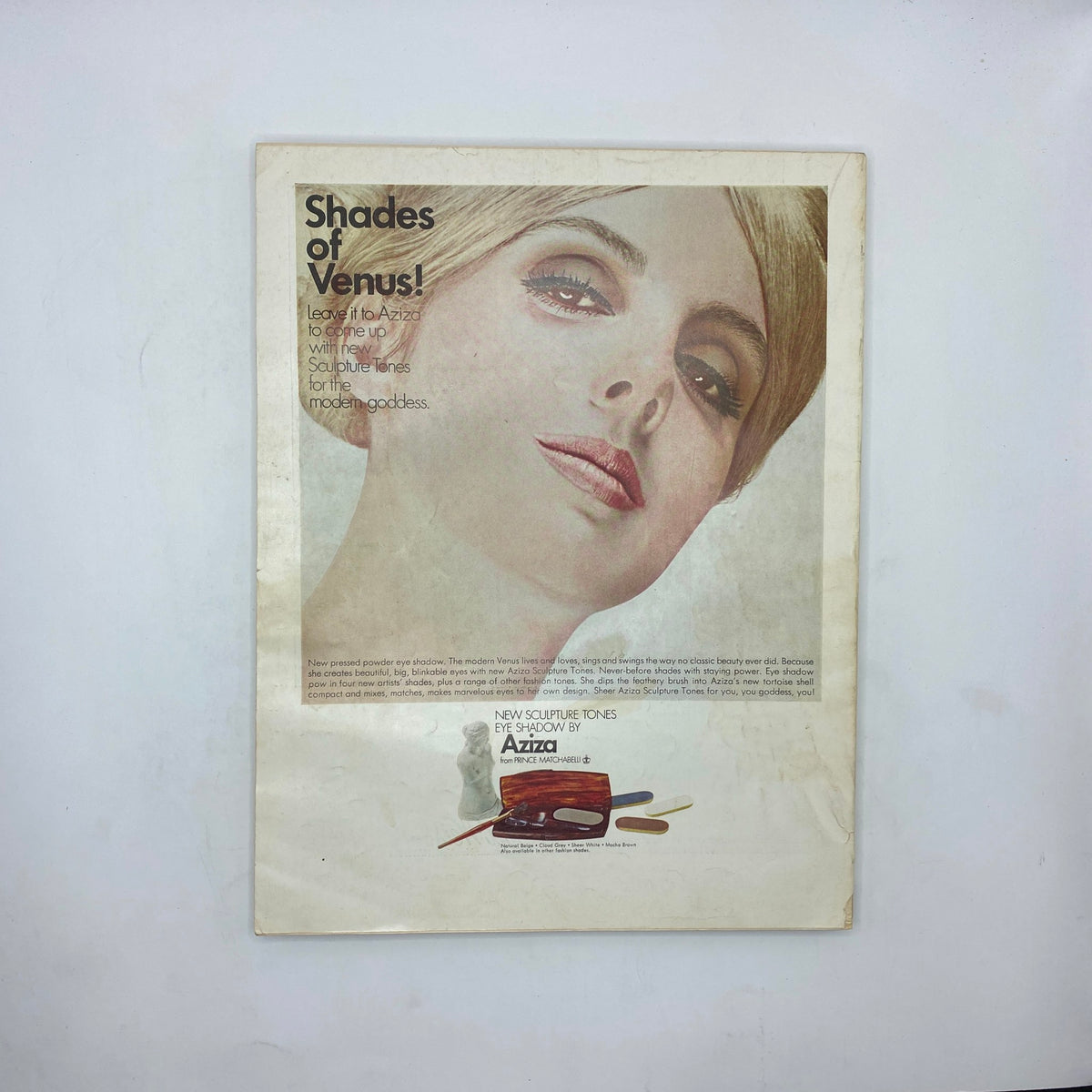 Vintage Vogue Magazine March 1 1967 ad for Aziza eye shadow, featuring a close-up of a model's face with elegant makeup, showcasing modern beauty trends.