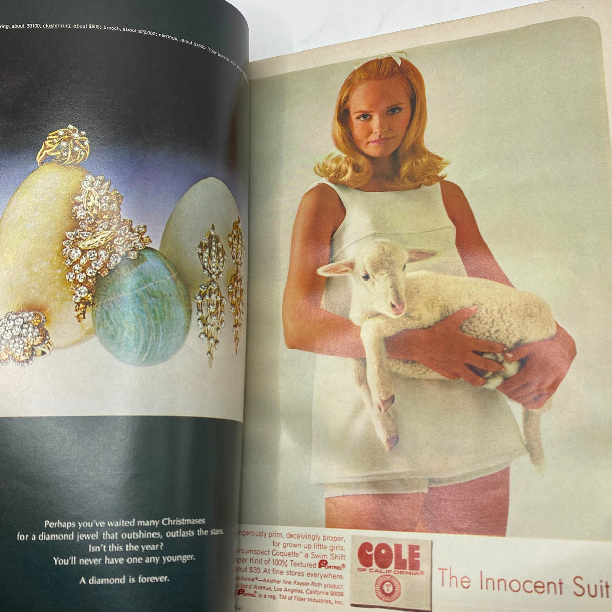 Inside page of the VTG Vogue Magazine November 1 1967 featuring a model holding a lamb, showcasing 1960s fashion styles and elegant jewelry options. Photographed by Irving Penn.