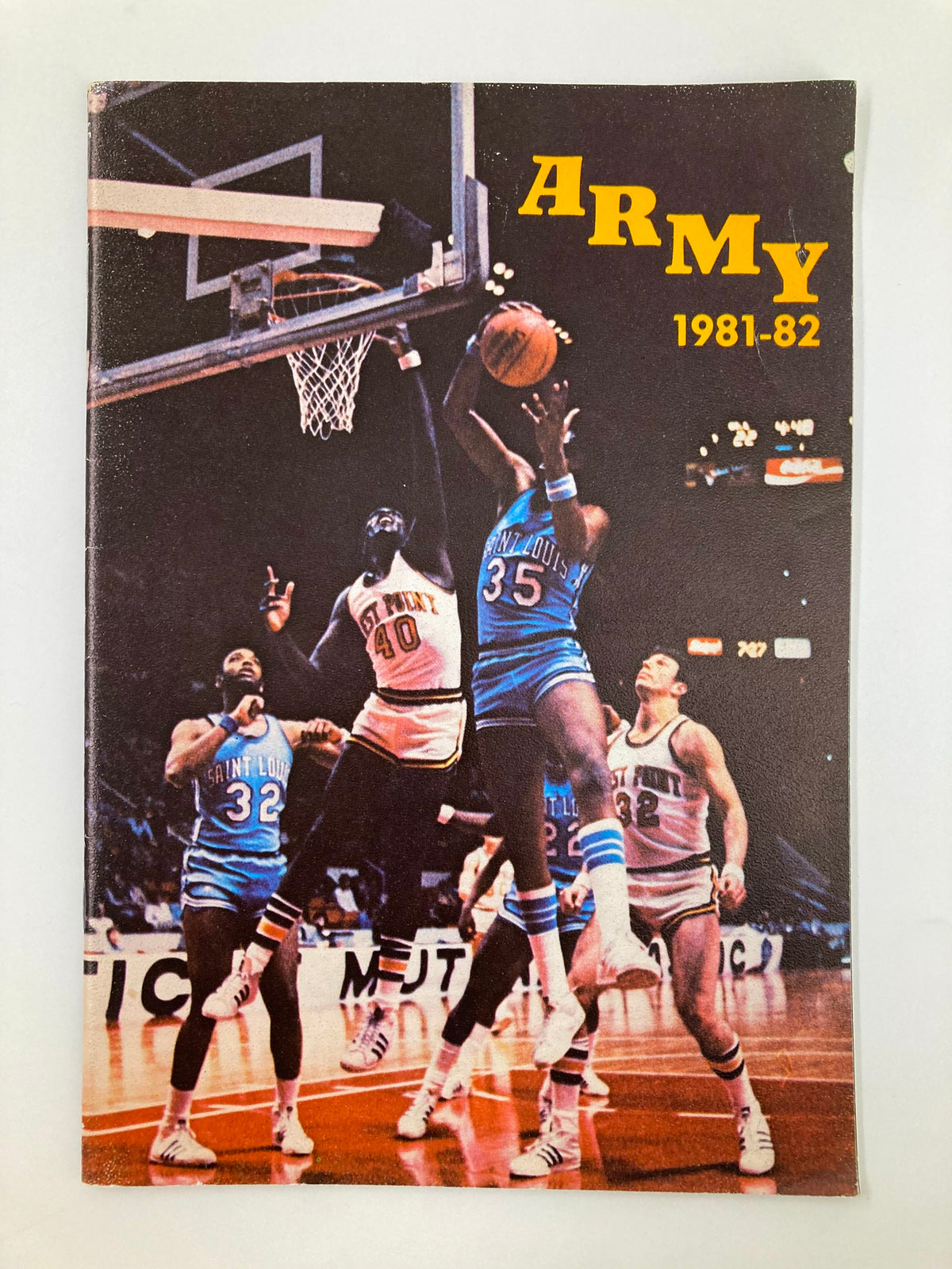 Cover of the 1981-1982 Army Captain Mike Spencer U.S. Military Academy Basketball Guide featuring a dramatic game scene.