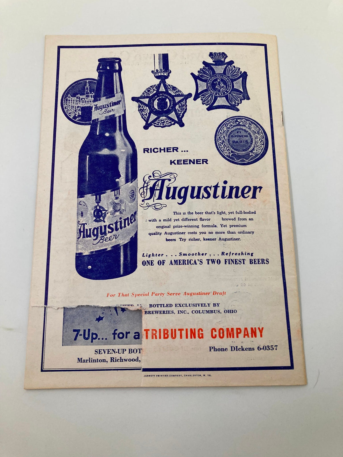 1961 Charleston Marlins Watt Powell Park Official Score Book displaying an advertisement for Augustiner Beer with medals, emphasizing its unique flavor and quality.