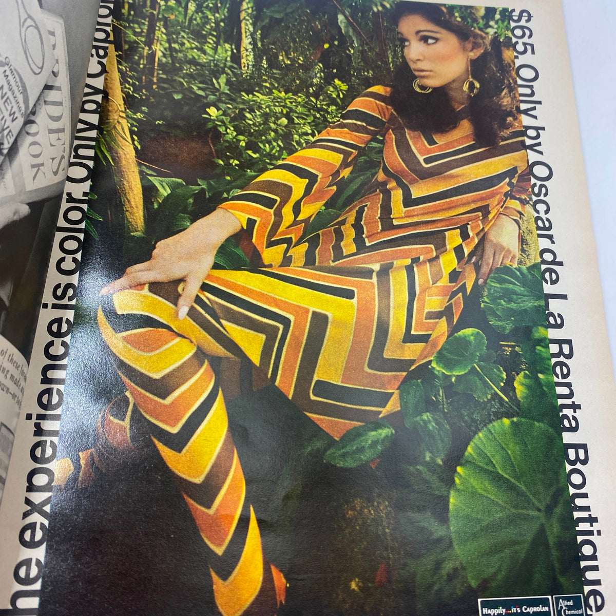 VTG Vogue Magazine March 15 1967 - Lauren Hutton showcasing a model in a vibrant color block outfit in a lush, green setting.