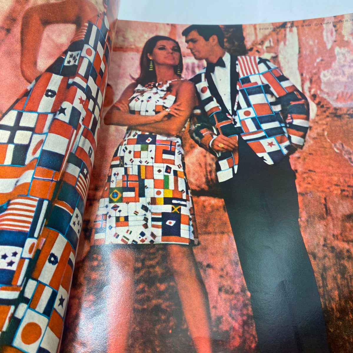 VTG Vogue Magazine March 15 1967 - Lauren Hutton presenting a couple in matching flag-patterned outfits against a textured backdrop.