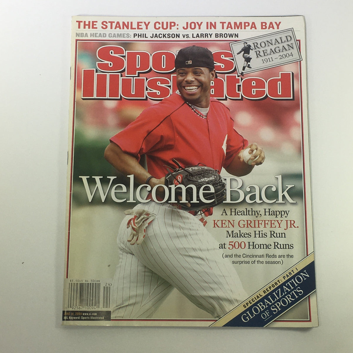 Cover of Sports Illustrated Magazine June 14, 2004 featuring Ken Griffey Jr. with the headline 'Welcome Back', highlighting his return to baseball. Also pays tribute to Ronald Reagan, 1911-2004, showcasing the intersection of sports and politics.