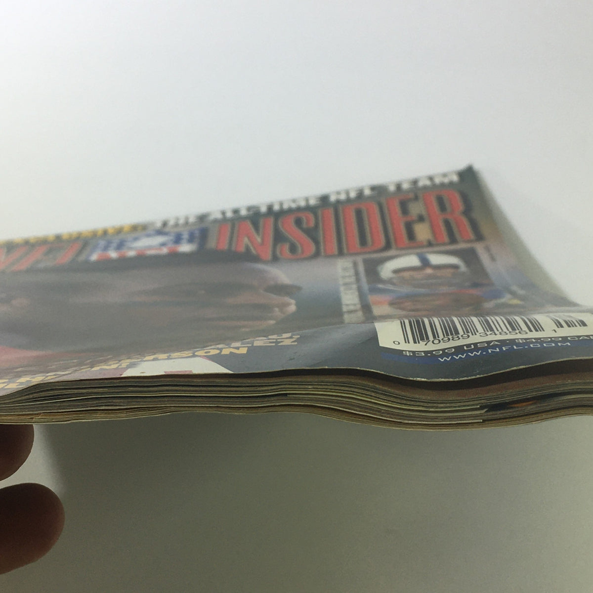 Side view of the NFL Insider Magazine from September 2000, showcasing its well-preserved condition with minor wear, relevant for collectors of vintage football memorabilia.