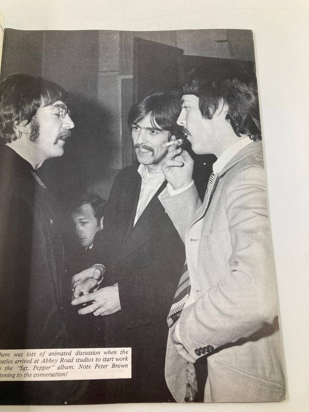 The Beatles Book Monthly Magazine January 1987 #129 Paul's Childhood features John Lennon, George Harrison, and Paul McCartney in an animated discussion at Abbey Road studios, highlighting historical moments in music.