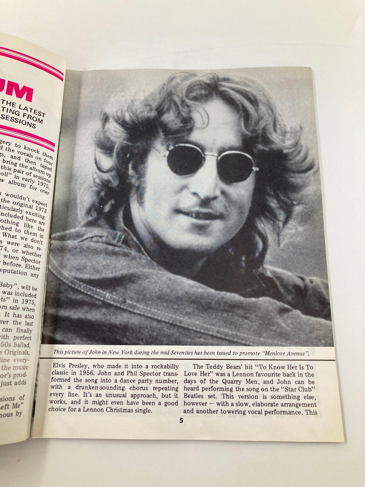 Black and white photograph of John Lennon featured in The Beatles Book Monthly Magazine December 1986 Issue #128, highlighting his iconic style with sunglasses.
