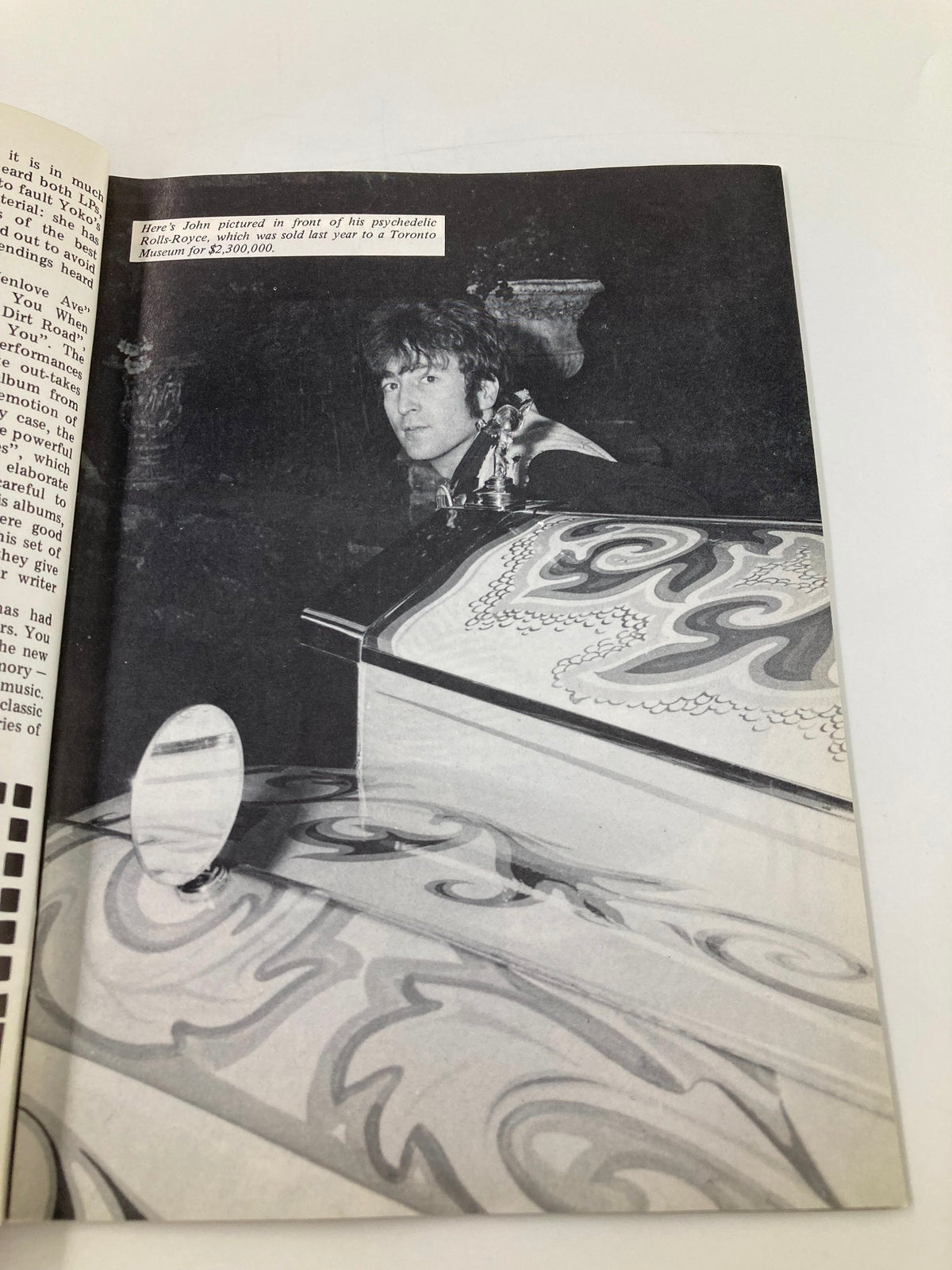 Vintage photograph featuring John Lennon in front of his psychedelic Rolls-Royce, from The Beatles Book Monthly Magazine December 1986 #128, showcasing iconic moments of The Beatles' legacy.