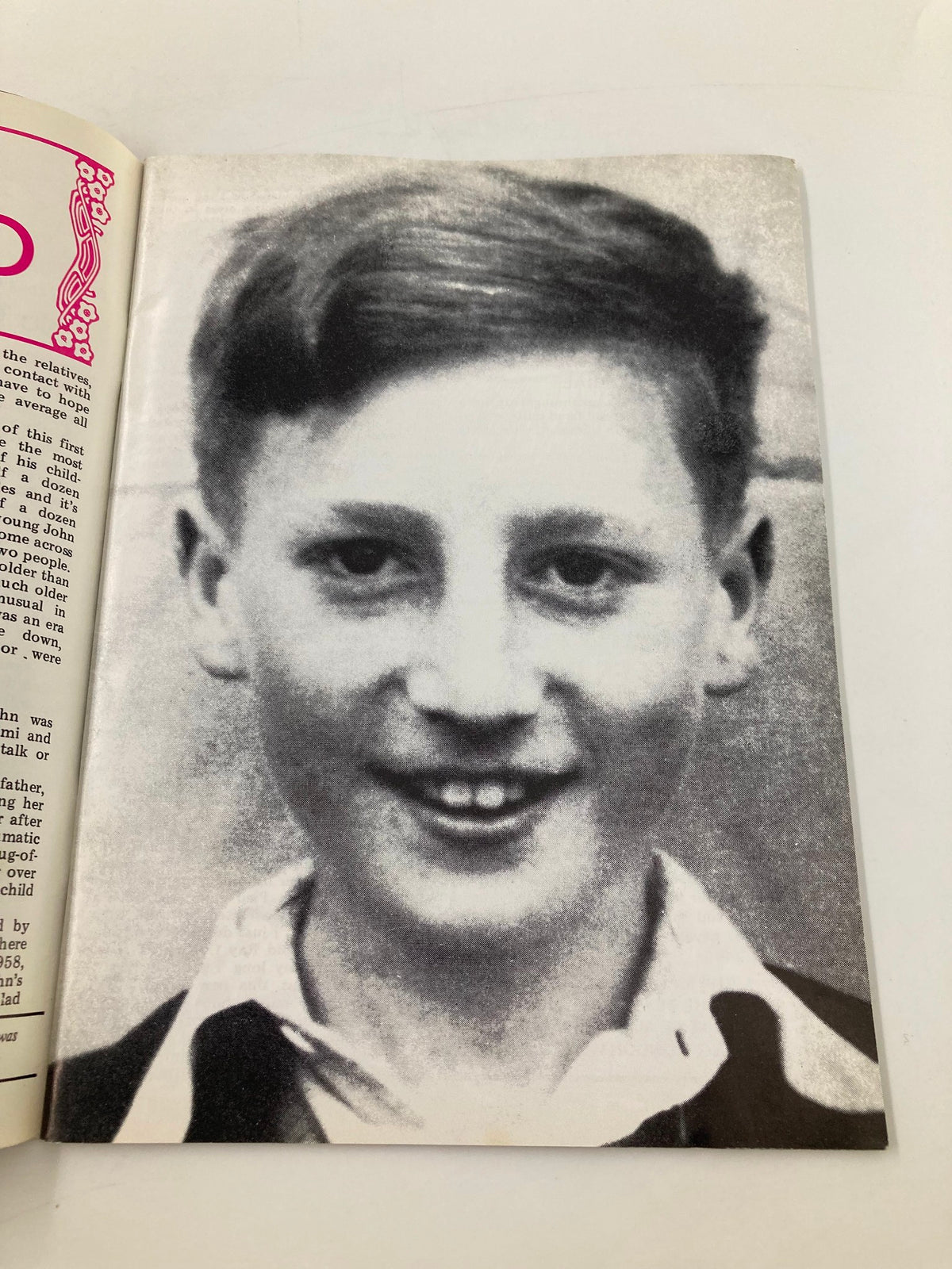 Black and white photograph of a young John Lennon featured in The Beatles Book Monthly Magazine October 1986 #126, capturing his childhood features.