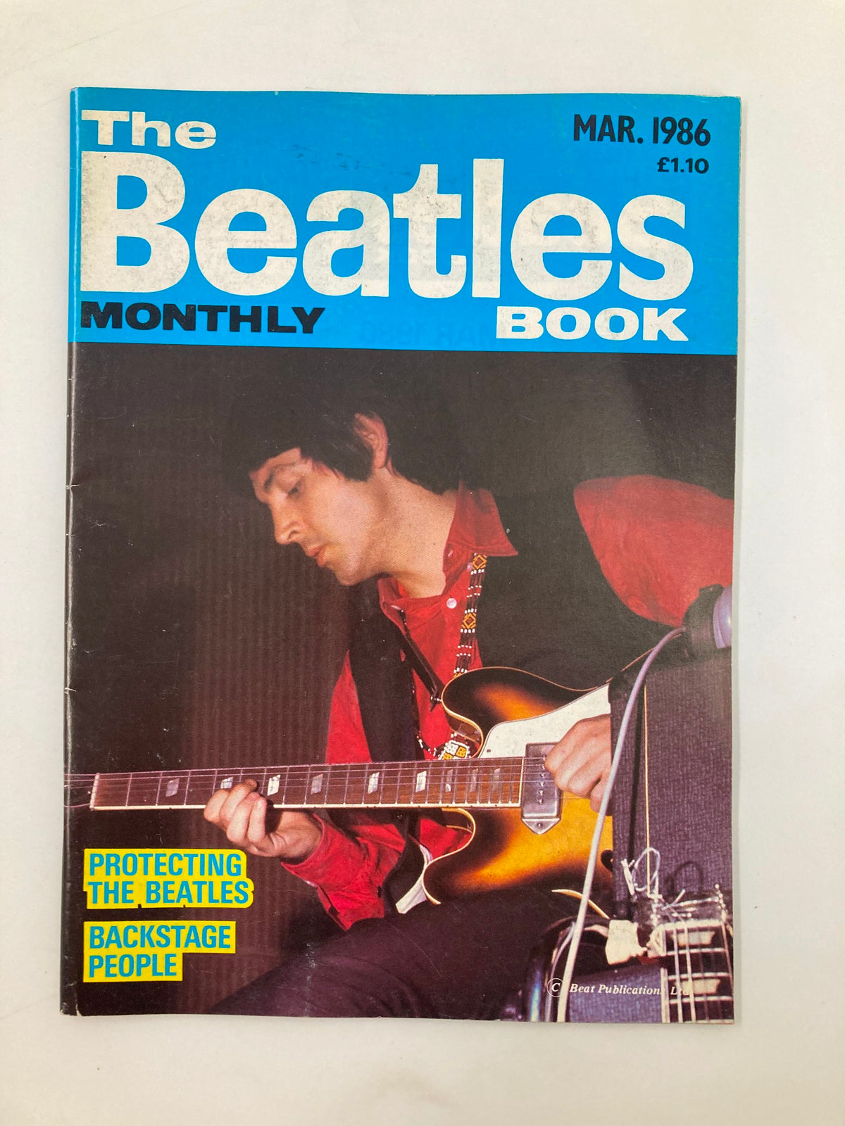 Cover of The Beatles Book Monthly Magazine, March 1986, Issue #119 featuring Paul McCartney playing guitar, showcasing its vintage appeal for collectors.
