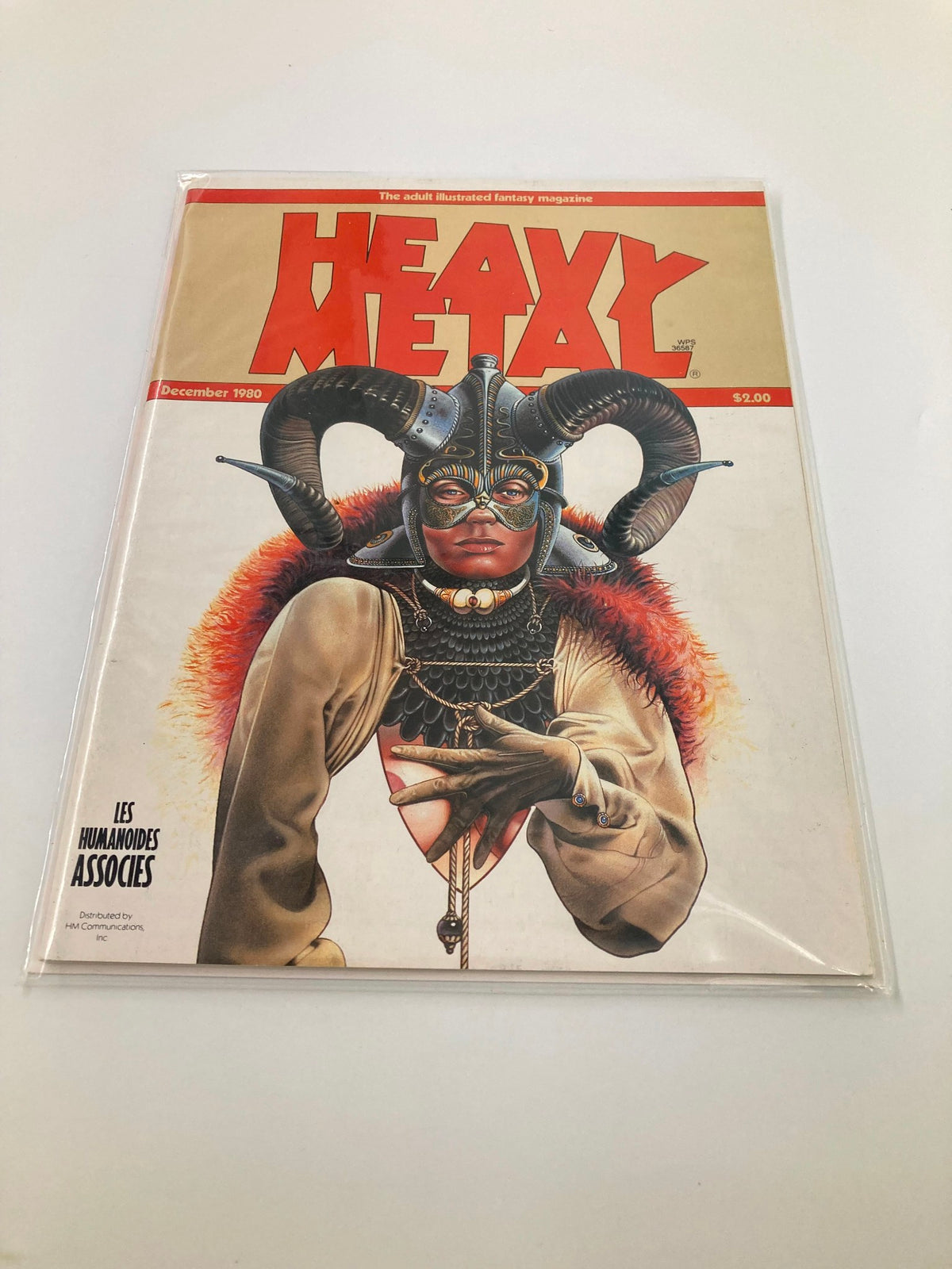 VTG Heavy Metal Magazine December 1980 in protective plastic cover, displaying the stunning cover art by Christos Achilleos, emphasizing its near mint condition.