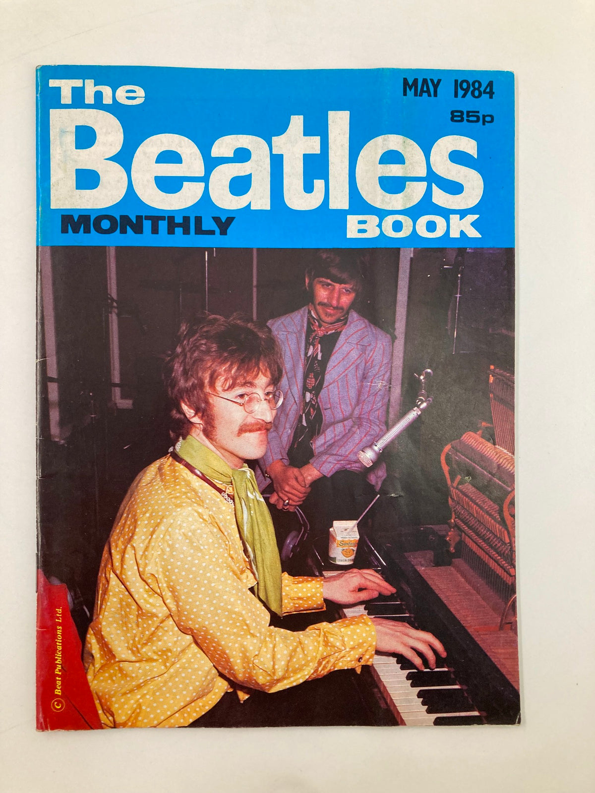 The Beatles Book Monthly Magazine May 1984 Issue #97 featuring a vibrant cover with classic colors and imagery of John Lennon at the piano. A nostalgic collectible for fans of the band and vintage magazine enthusiasts, highlighting the film 'A Hard Day's Night'.