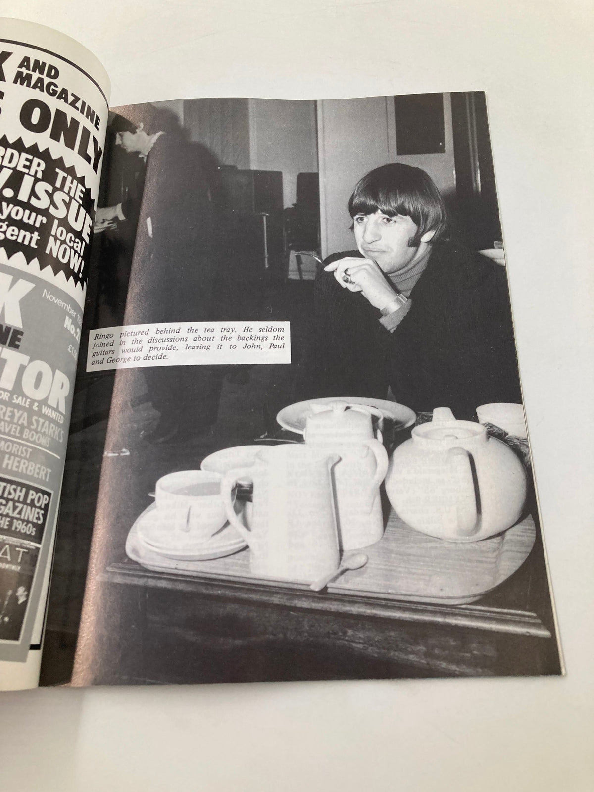 The Beatles Book Monthly Magazine November 1985 showcasing a black and white image of Ringo Starr during a discussion, with tea service items on the table.