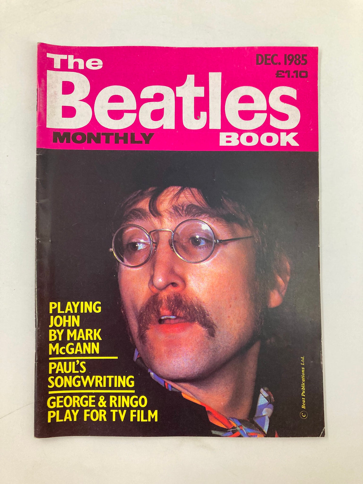 Cover of The Beatles Book Monthly Magazine, December 1985 Issue #116 featuring a portrait of a band member with round glasses and a mustache, highlighting featured articles about Paul McCartney and George & Ringo.