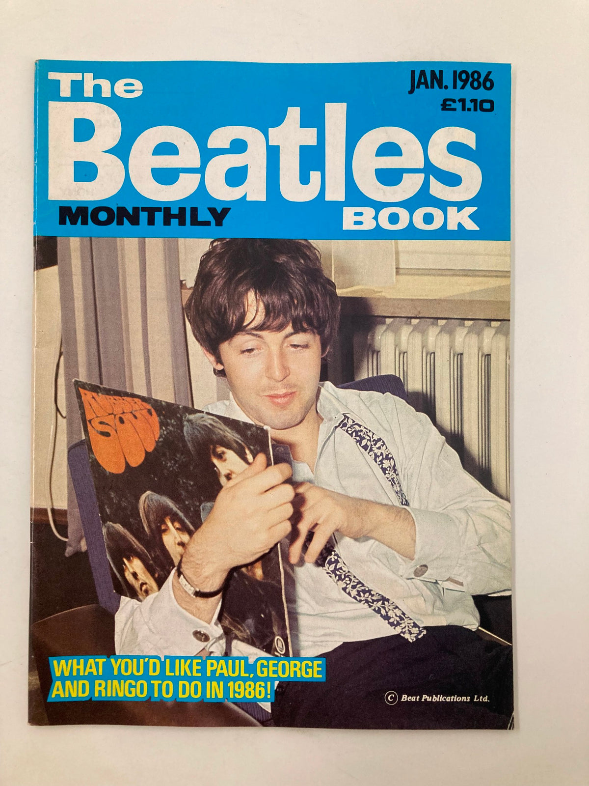 The Beatles Book Monthly Magazine January 1986 #117 featuring Paul McCartney on the cover, showcasing vibrant blue background and images of the band.