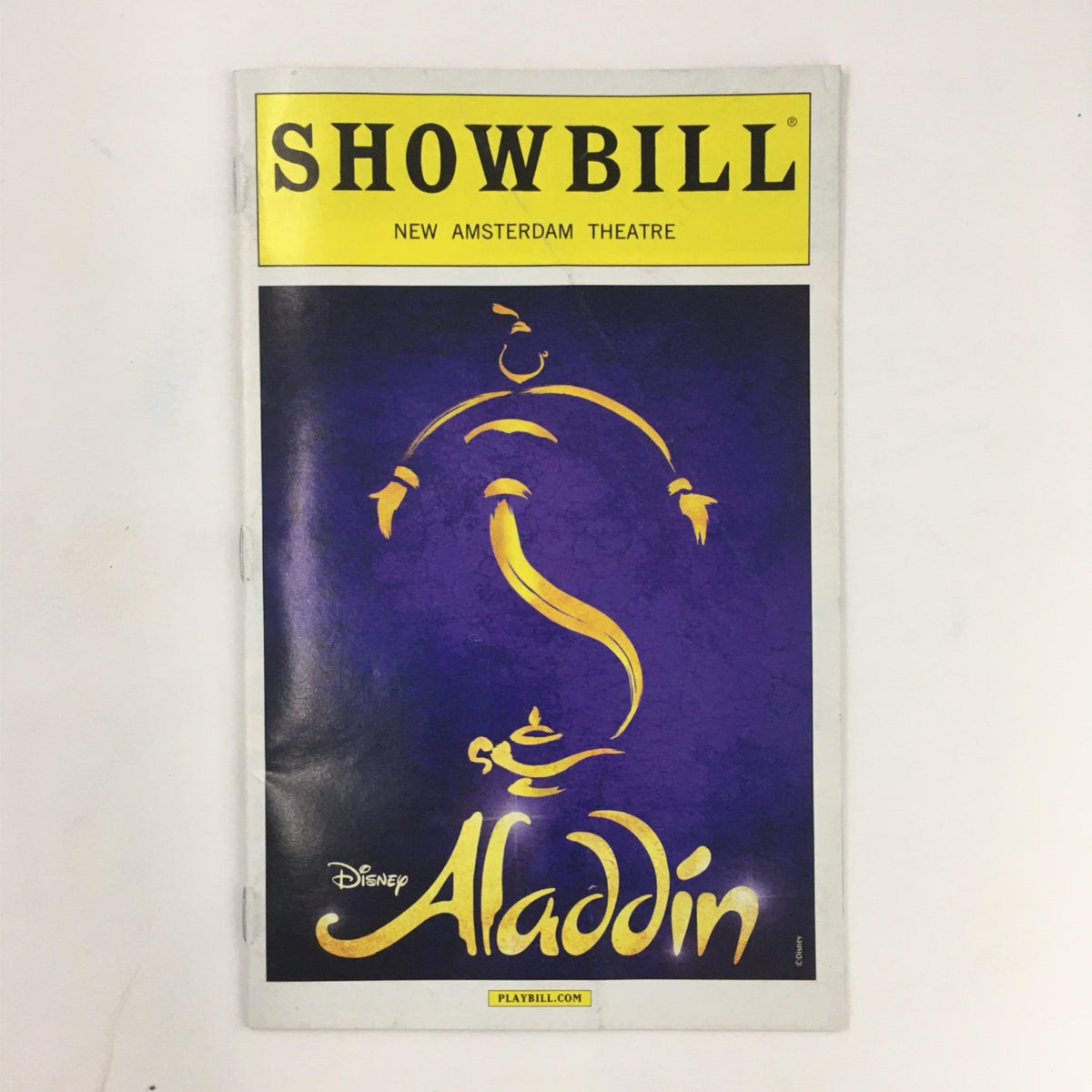 2014 Showbill for Disney's Aladdin by Casey Nicholaw at New Amsterdam Theatre, featuring a vibrant cover design with a silhouette of the Genie.