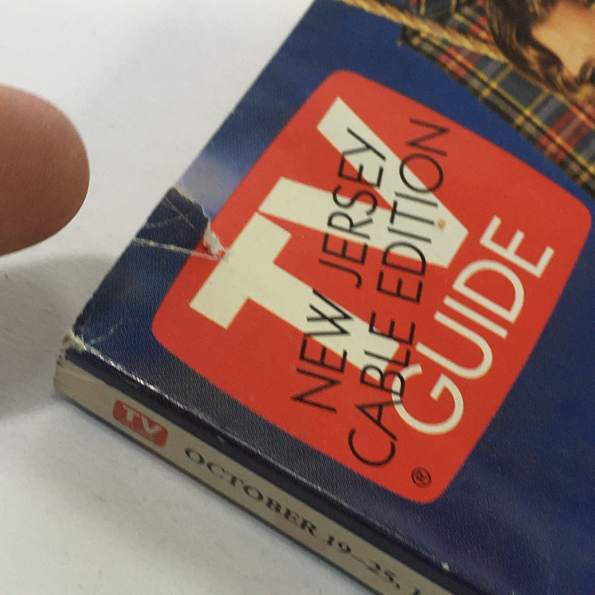 Close-up of the top left corner of the TV Guide magazine from October 19-25 1996, with visible wear showing the title and publication date for collectors.
