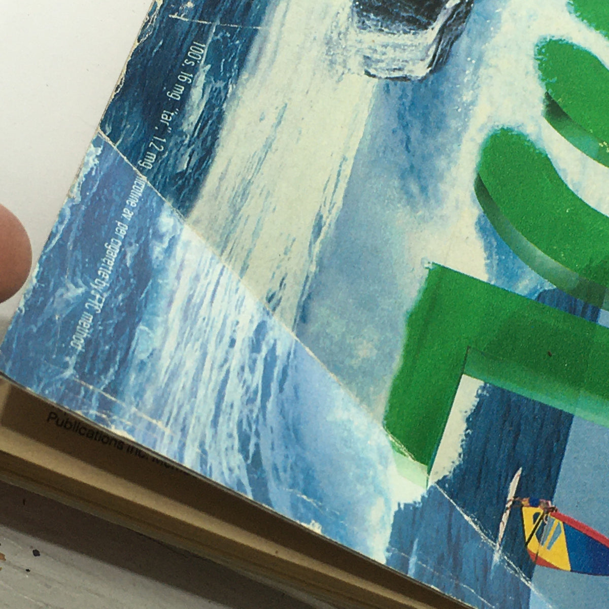 Close-up of the edge of the vintage TV Guide magazine dated June 24-30, 1995, featuring Jason David Frank as the White Ranger, showcasing the magazine's weathered condition and colorful cover.