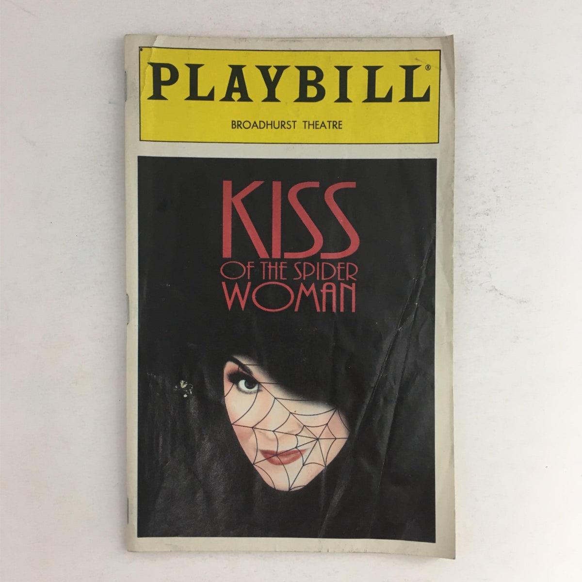 1993 Playbill for Kiss of the Spider Woman featuring Chita Rivera, displayed at Broadhurst Theatre with a striking cover design featuring a spider web and actress' face.