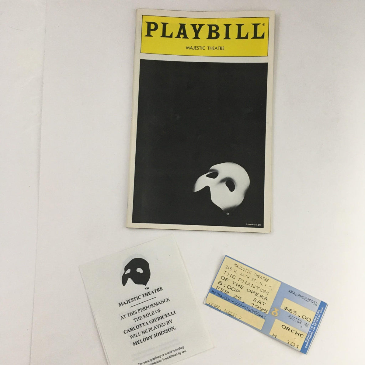 1995 Playbill Phantom of the Opera, Davis Gaines Harold Prince, Majestic Theatre showing the iconic mask cover, along with a ticket and performance card.