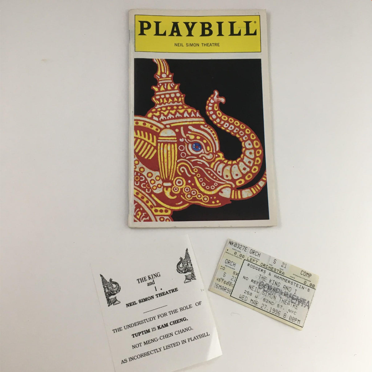 1996 Playbill for The King and I featuring an ornate elephant design, showcasing the Neil Simon Theatre branding.