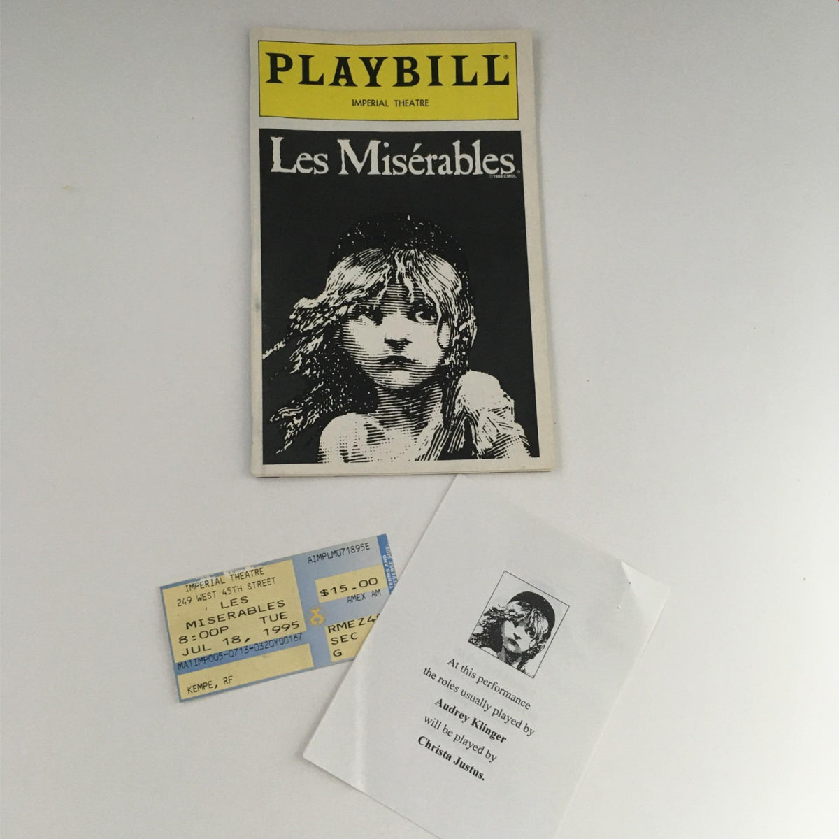 1995 Playbill Les Misérables by Victor Hugo, featuring iconic cover art with a depiction of a young girl, along with the original ticket from the Imperial Theatre July 18, 1995.