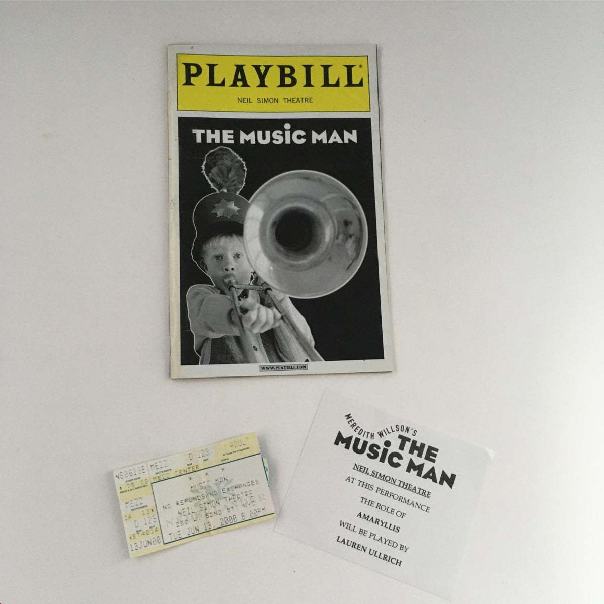 2000 Playbill The Music Man featuring a boy playing a trumpet, including original ticket and promotional materials from the Neil Simon Theatre.