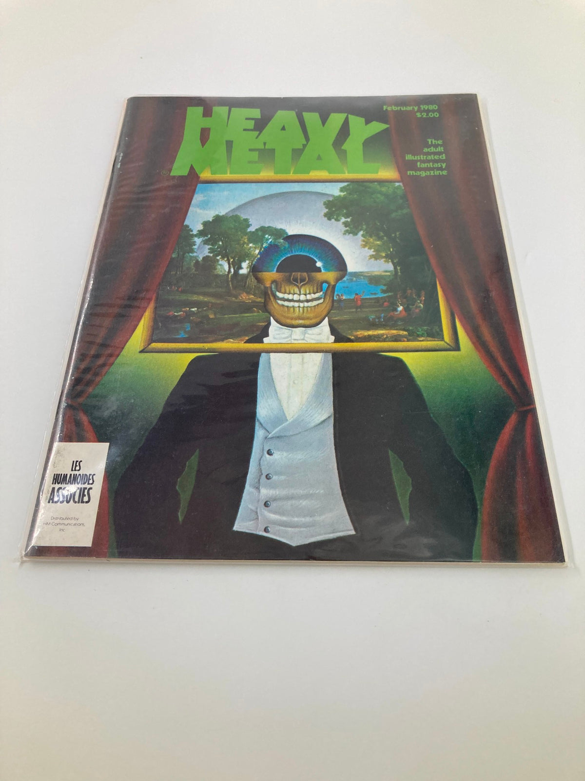 Cover of VTG Heavy Metal Magazine February 1980 featuring artwork of Mr. Interlocutor and Mr. Bones, showcasing a skull-headed figure framed by curtains in a vibrant fantasy setting.