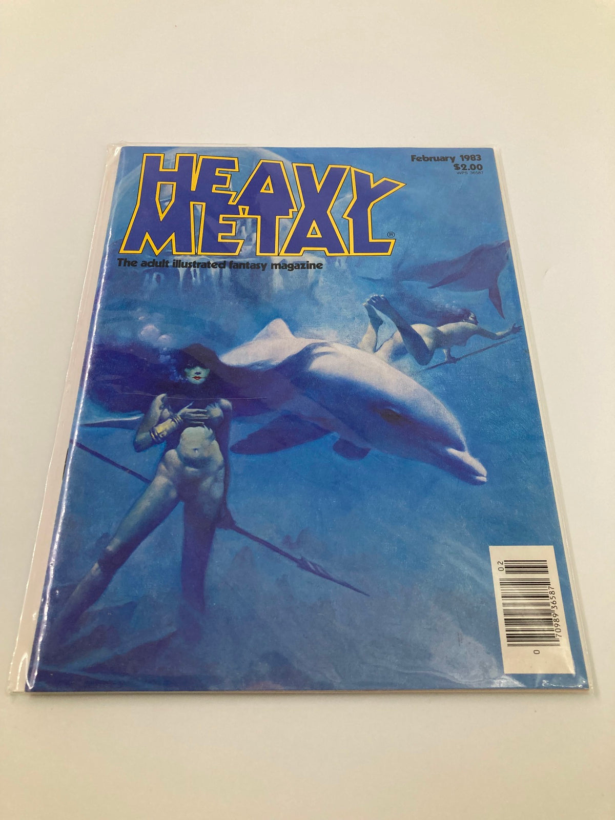 Back cover view of VTG Heavy Metal Magazine February 1983 showing the magazine protected in plastic, highlighting its near mint condition and iconic cover artwork.