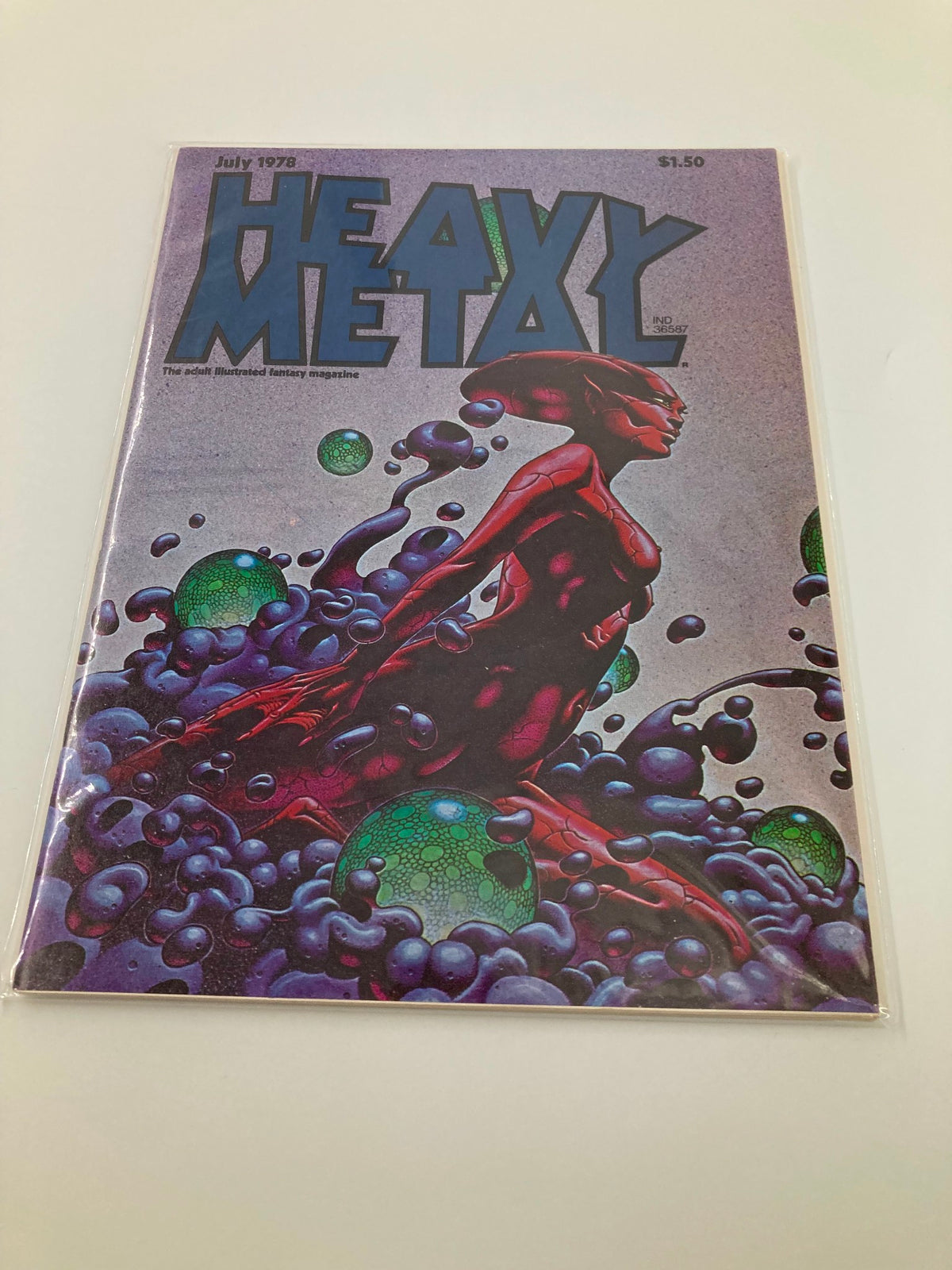 Cover of the Heavy Metal Magazine July 1978, featuring a vibrant illustration with a red figure and colorful bubbles, highlighting the magazine's unique fantasy and sci-fi art.