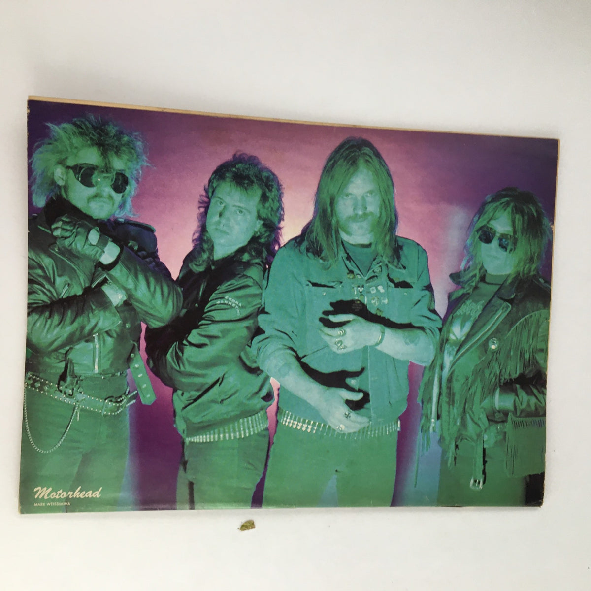 Vintage magazine poster featuring the iconic rock band Motörhead, associated with the Rock Magazine February 1989 titled 'Rock N' Roll Heaven with Stryper'. This colorful image showcases the band members in leather jackets with a vibrant background, highlighting the bold fashion and electrifying rock culture of the late 1980s.