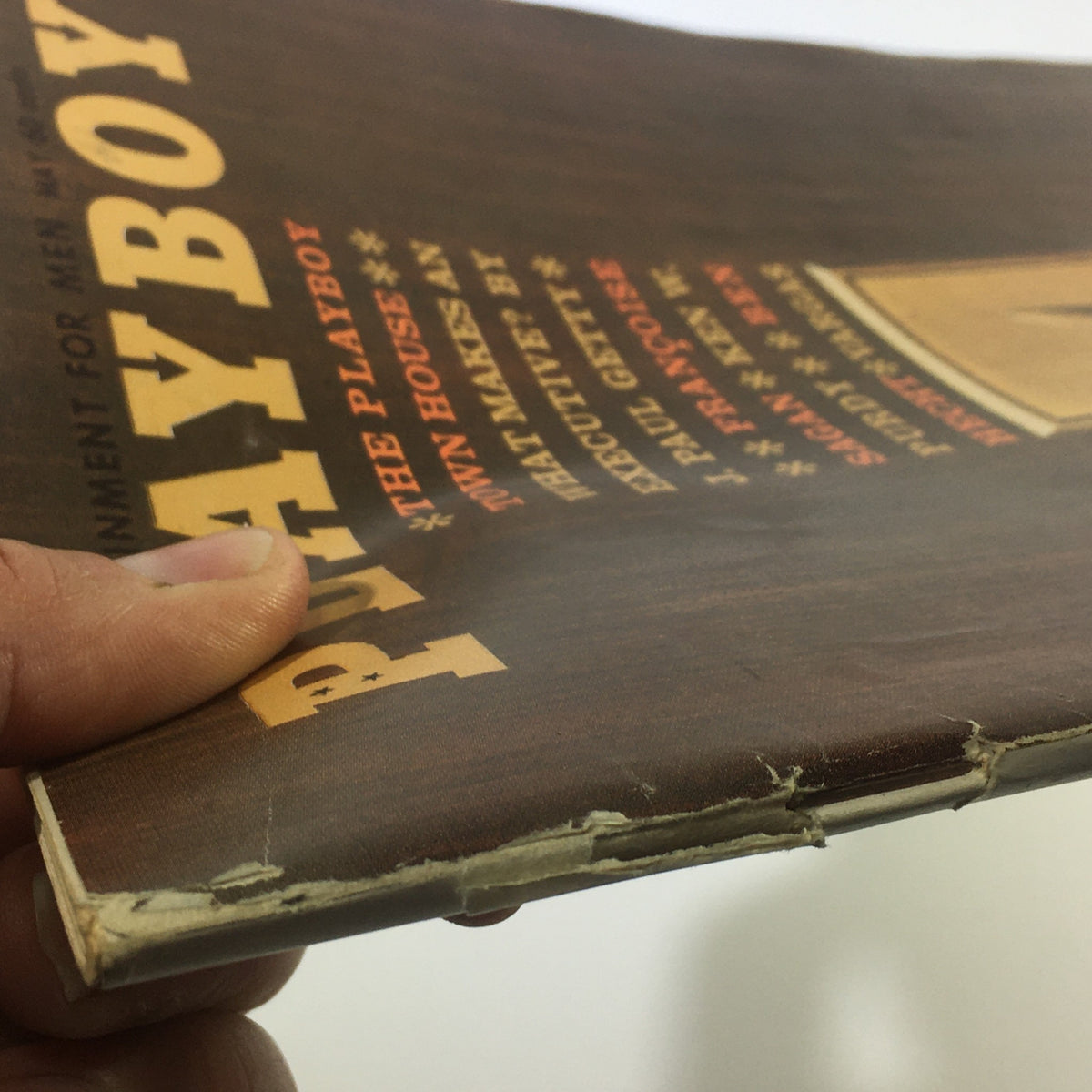 View of the damaged binding of the vintage Playboy Magazine May 1962 Vol. 9 #5, highlighting the wear and tear on the cover.