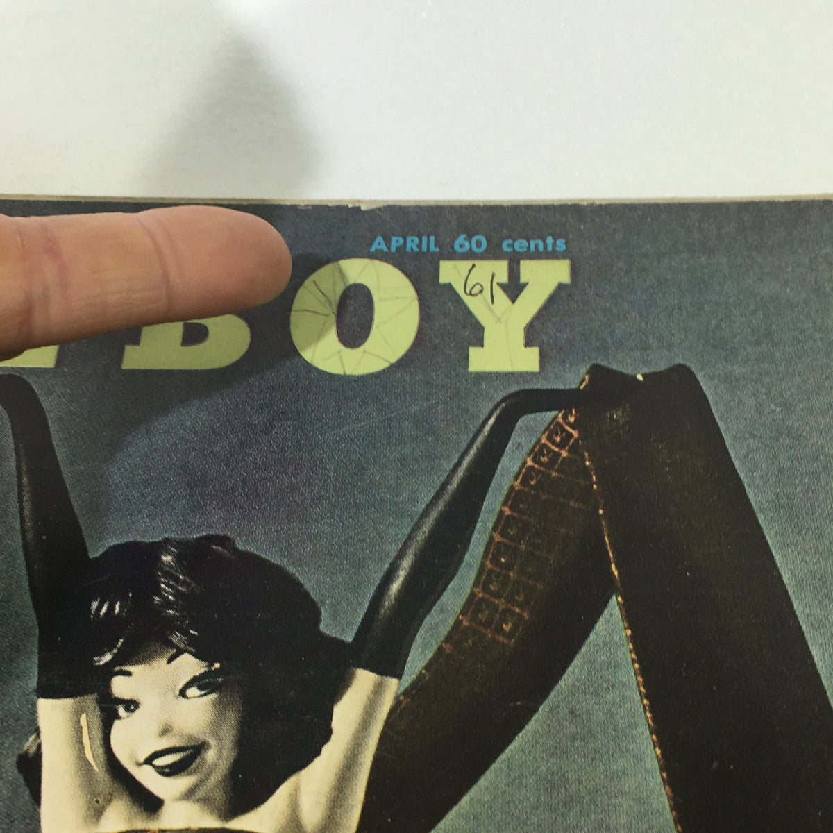 Close-up view of the VTG Playboy Magazine April 1961 cover highlighting the title and date, capturing vintage magazine attributes.