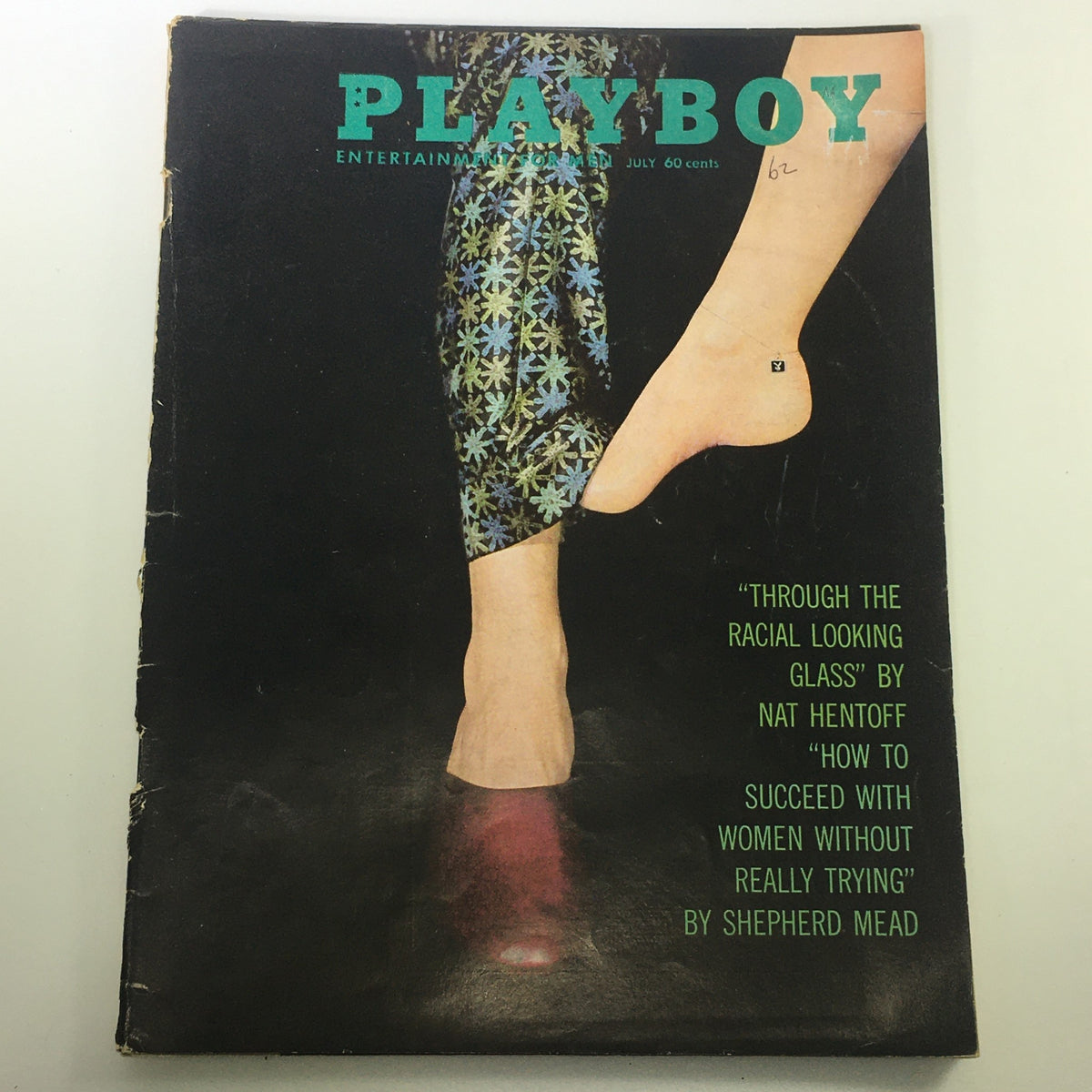 Cover of VTG Playboy Magazine July 1962 featuring the title and stylized leg design with colorful patterns.