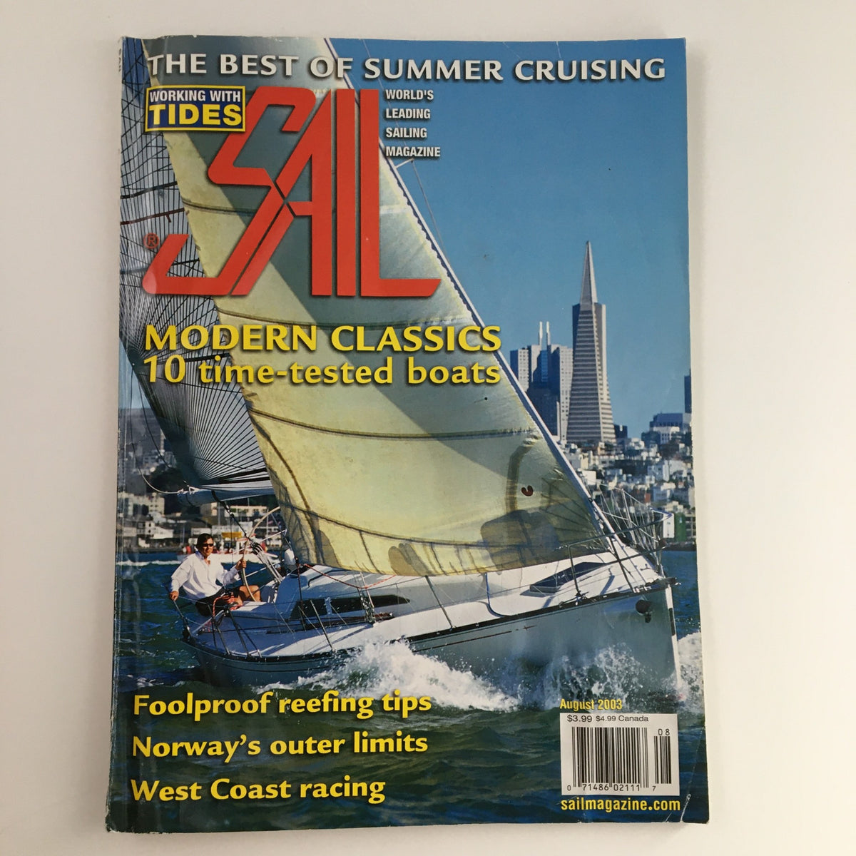 Cover of Sail Magazine August 2003 featuring a sailing boat and San Francisco skyline, showcasing key topics like modern classics and summer cruising tips.