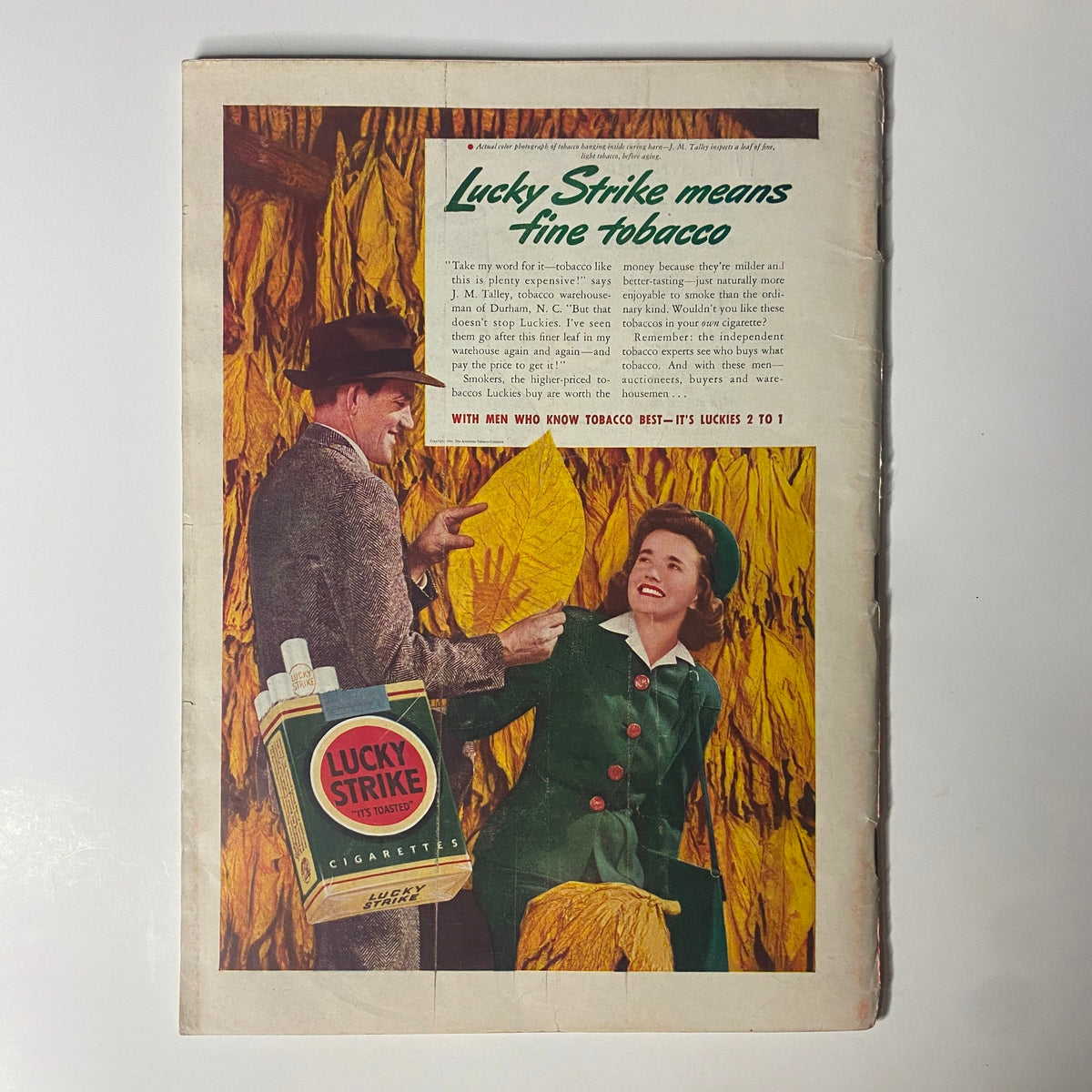 Vintage advertisement for Lucky Strike cigarettes, featuring a man and a woman among tobacco leaves, highlighting the slogan 'Lucky Strike means fine tobacco' from a magazine dated 1941.