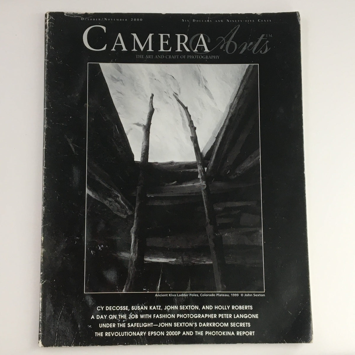 Camera Arts Magazine October 2000 cover showcasing ancient kiva leader poles by John Sexton, highlighting the art and craft of photography.