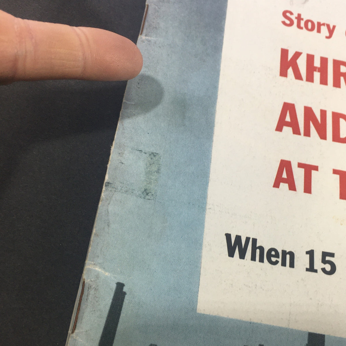 Close-up view of the edge of the vintage U.S. News & World Report magazine from September 26, 1960, featuring a story about Nikita Khrushchev. The image shows details of the magazine's spine and wear indicative of its age.