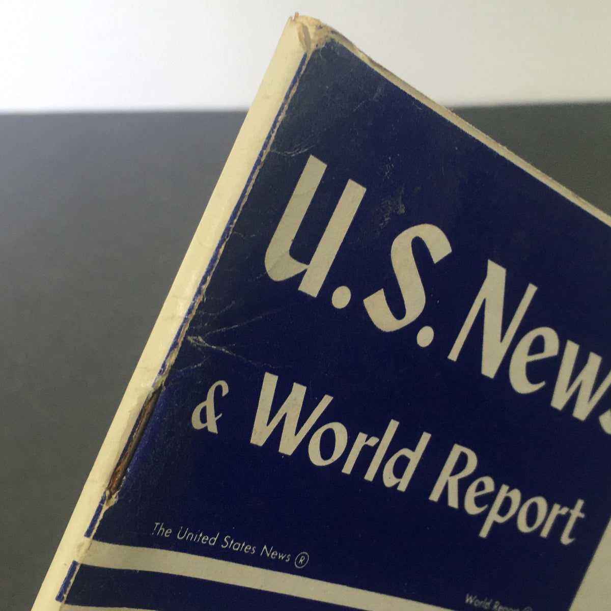 Close-up view of the vintage U.S. News & World Report magazine from October 26, 1959, showcasing the title 'U.S. News & World Report' and details of wear on the spine, reflecting its historical significance as a collectible item.