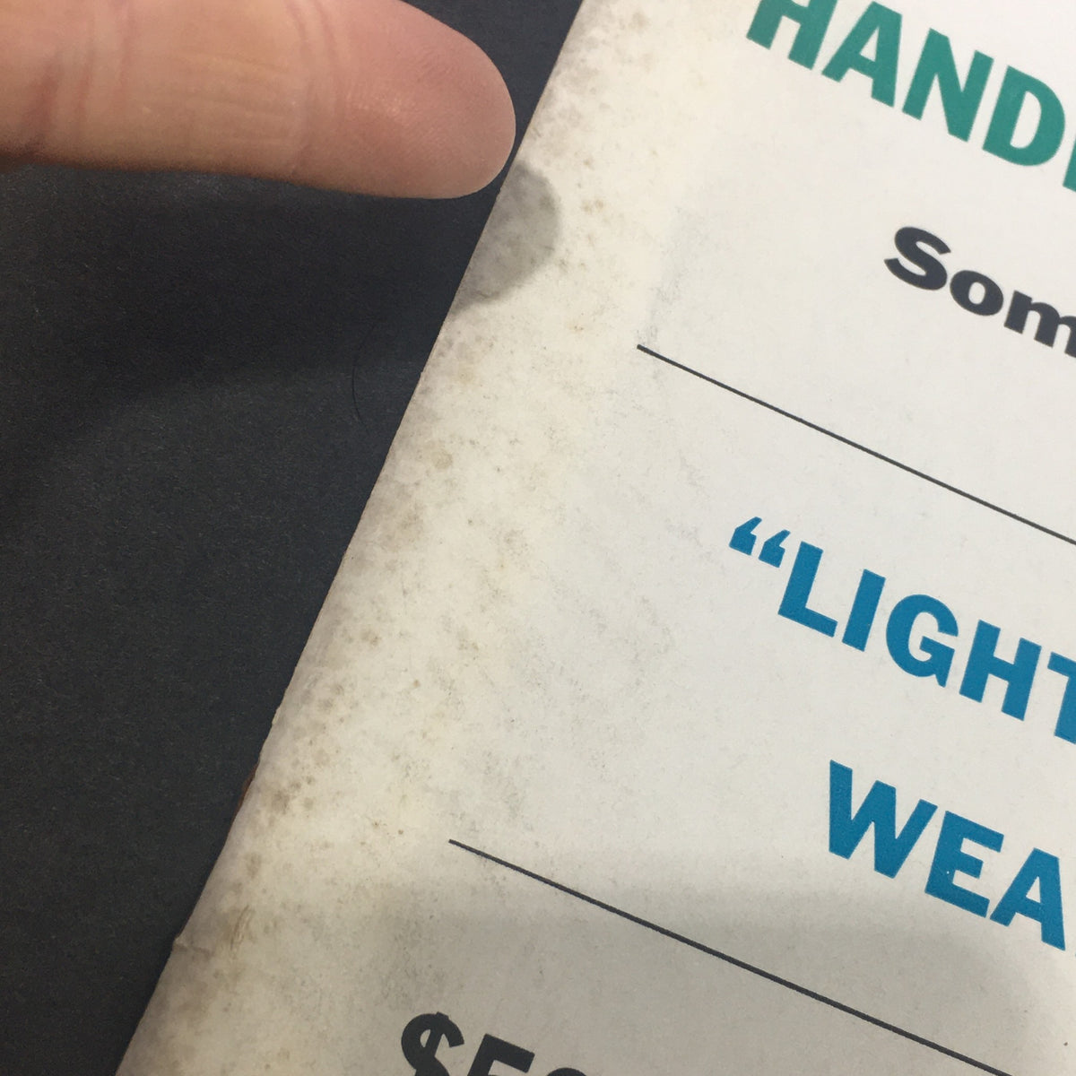 Close-up of the edge of a vintage U.S. News & World Report magazine from April 2, 1962, showing wear and tear, related to the cover story 'Balks at John F. Kennedy'.