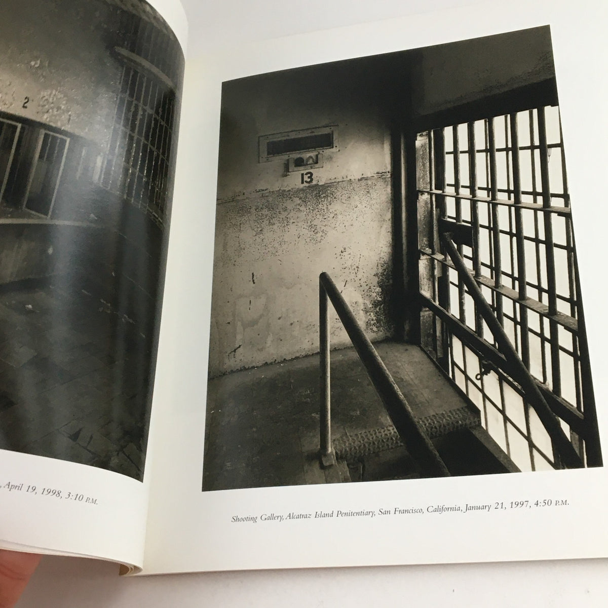 Black and white image of a corridor at Alcatraz Island Penitentiary, San Francisco, highlighting a window with the number 13, from Contact Sheet Number 110 January 2001 Margaret Stratton Light Work Portfolio.