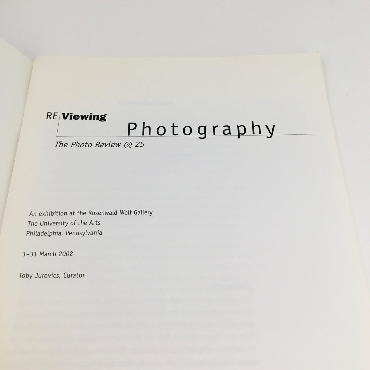Introduction page of Re-Viewing Photography March 2002, detailing the exhibition at the Rosenwald-Wolf Gallery, including information about the curator and event dates.